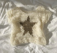 a white sweater with a star on it